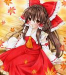  6kusa acrylic_paint_(medium) ascot bow brown_eyes brown_hair detached_sleeves hair_bow hair_tubes hakurei_reimu leaf long_hair looking_at_viewer maple_leaf sitting solo touhou traditional_media 