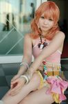  1girl belt bracelet checkered cosplay female final_fantasy final_fantasy_xiii jewelry midriff necklace oerba_dia_vanille oerba_dia_vanille_(cosplay) on_floor pink_shirt shirt sitting skirt solo tile tiles twintails window 