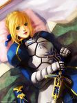  ahoge armor armored_dress artoria_pendragon_(all) blonde_hair blush caliburn dress elise_trinh fate/stay_night fate_(series) gauntlets green_eyes hair_ribbon lipstick makeup on_bed pillow puffy_sleeves ribbon saber sheath signature smile solo sword watermark weapon web_address 