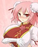  bandages blush breast_hold breasts bun_cover directional_arrow double_bun flower huge_breasts ibaraki_kasen looking_at_viewer oro_(zetsubou_girl) pink_background pink_hair red_eyes ribbon rose short_hair solo sweat touhou upper_body wavy_mouth 
