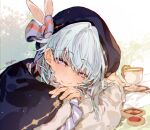  1boy blue_bow blue_cape blue_hat blush bow cape checkerboard_cookie closed_mouth cookie cup ensemble_stars! food half-closed_eyes hat hat_bow leaning_forward long_sleeves looking_at_viewer puffy_long_sleeves puffy_sleeves sapphire_(nine) shino_hajime shirt smile solo teacup thumbprint_cookie white_shirt 