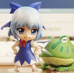  1girl blue_dress blue_eyes blue_hair cirno computer crystal dress female figure frog hands_on_hips lowres nendoroid no_humans photo ribbon smile solo standing touhou 