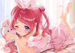  1girl animal_ears barefoot blue_eyes blush breasts commentary_request gakuen_idolmaster hanami_saki highres idolmaster lllllaaaaauuu long_hair looking_at_viewer negligee on_bed one_eye_closed pink_negligee rabbit_ears red_hair smile solo stuffed_toy two_side_up 