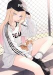  1girl absurdres animal animal_on_lap baseball_cap blonde_hair blue_eyes cat chain-link_fence closed_mouth clothes_writing commentary eyes_visible_through_hair fence gakuen_idolmaster hand_on_headwear hat highres idolmaster juo_sena lisu long_hair long_sleeves looking_at_viewer on_lap outdoors shirt shoes sitting sleeves_past_wrists sneakers socks solo untranslatable_commentary white_shirt white_socks 