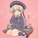  1girl blue_dress blue_eyes blue_sailor_collar blue_socks blush clothes_writing commentary_request dated dress hair_between_eyes hat kantai_collection long_sleeves looking_at_viewer parted_lips pink_background sailor_collar sailor_dress sailor_hat sanada_nako short_dress short_hair simple_background sitting sleeves_past_wrists socks solo sparkle twitter_username z1_leberecht_maass_(kancolle) 