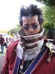  armor auron beard black_eyes black_hair closed_mouth coat cosplay day facial_hair final_fantasy final_fantasy_x lips looking_at_viewer male_focus one_eye_closed photo red_coat scar scar_across_eye shoulder_pads silver-framed_eyewear solo_focus sunglasses thick_eyebrows tree upper_body 