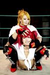  2girls arena blonde_hair boxing_ring candy_cane_(rumble_roses) candy_cane_(rumble_roses)_(cosplay) chouzuki_maryou cosplay fingerless_gloves gloves mistress_spencer mistress_spencer_(cosplay) multiple_girls photo red_hair rumble_roses rumble_roses_xx sitting sitting_on_person wrestling 