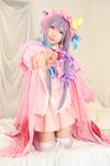  1girl asian bed cosplay crescent dress female hat long_hair patchouli_knowledge photo pillow purple_hair solo tenshi_myu touhou 