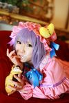  1girl asian cosplay couch cream crescent dessert dress female food hat highres long_hair patchouli_knowledge photo purple_hair solo tenshi_myu touhou 