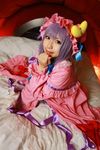  1girl asian bed blanket cosplay crescent dress female hat highres long_hair patchouli_knowledge photo pillow purple_hair solo tenshi_myu touhou 