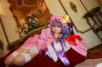  1girl asian cosplay couch crescent dress female hat long_hair patchouli_knowledge photo purple_hair solo tenshi_myu touhou 