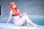  asian barefoot bikini cosplay highres lying neon_genesis_evangelion orange_hair photo pool soryu_asuka_langley swimsuit tanaka_mana water 