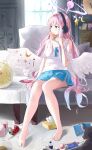  1girl absurdres angel_wings barefoot bed bed_sheet blue_archive blue_shorts blush bottle breasts camisole can cellphone crescent crescent_pin dolphin_shorts drinking_straw feathered_wings food halo headphones highres holding holding_food indoors jsscj long_hair medium_breasts mika_(blue_archive) phone pink_hair pink_halo popsicle shorts sitting smartphone solo tissue tissue_box toes white_camisole white_wings wings yellow_eyes 