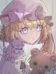  1girl alternate_costume blonde_hair closed_mouth collar flandre_scarlet frilled_collar frills grey_eyes hat hat_ribbon highres holding_teddy_bear kopi_(user_ajtn7422) long_hair long_ribbon looking_at_viewer mob_cap pajamas red_ribbon ribbon side_ponytail signature solo stuffed_animal stuffed_toy teddy_bear touhou upper_body white_background white_hat white_pajamas 