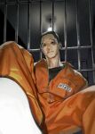  1boy 3367e black_eyes black_hair black_shirt blood bruise bruise_on_face bruised_eye ceiling_light character_request chinese_commentary commentary_request highres indoors injury iron_bars jumpsuit killing_stalking male_focus nosebleed orange_jumpsuit prison_clothes prisoner shaved_head shirt shoes sitting solo undershirt white_shoes zipper zipper_pull_tab 