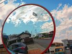  chain-link_fence cloud day doraemon doraemon_(character) fence flying ground_vehicle highres house mirror motor_vehicle no_humans reflection road ryoun sky street takecopter traffic_mirror vanishing_point 