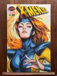  1girl blue_eyes bodysuit breasts commentary cover_sketch english_commentary fiery_hair fire highres jean_grey large_breasts long_hair looking_at_viewer marker_(medium) marvel multicolored_bodysuit orange_hair parted_lips photo_(medium) signature skin_tight solo stanley_lau traditional_media two-tone_bodysuit upper_body x-men 