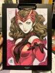  1girl artist's_hand_in_frame blue_eyes bodysuit breasts brown_hair closed_mouth commentary english_commentary highres large_breasts long_hair looking_at_viewer marker_(medium) marvel multicolored_bodysuit photo_(medium) red_bodysuit red_tiara scarlet_witch signature solo stanley_lau superhero_costume traditional_media two-tone_bodysuit upper_body 