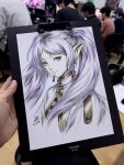  1girl artist's_hand_in_frame blue_eyes capelet closed_mouth commentary cropped_torso earrings elf english_commentary frieren highres jewelry looking_at_viewer marker_(medium) photo_(medium) pointy_ears signature smile solo sousou_no_frieren stanley_lau teardrop_earrings traditional_media twintails white_capelet white_hair 