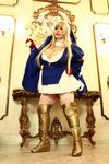  1girl asian blonde_hair breasts cleavage cosplay cross fat huge_breasts luu_(cosplayer) photo queen&#039;s_blade siggy siggy_(cosplay) solo 