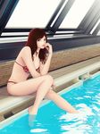  barefoot bikini breasts drain_(object) green_eyes highres indoors khalitzburg lipstick long_hair makeup medium_breasts nail_polish original pool poolside red_hair rei_no_pool sitting soaking_feet solo swimsuit water window 