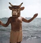  beach bovine cattle fursuit horn human invalid_tag mammal minotaur not_furry pablo_picasso photo raised_arm real sea seaside topless water what 