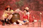  2girls barrel cosplay cup genderswap giraffe hat monkey_d_luffy monkey_d_luffy_(cosplay) mug multiple_girls octopus one_piece photo portgas_d_ace portgas_d_ace_(cosplay) red_vest shorts sitting straw_hat thigh_strap toy vest 