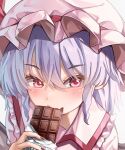  1girl blue_hair candy chocolate chocolate_bar collared_shirt commentary_request eating food hat hat_ribbon highres looking_at_viewer maboroshi_mochi mob_cap pink_headwear pink_shirt portrait red_eyes red_ribbon remilia_scarlet ribbon shirt solo touhou white_background 