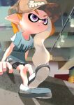  1girl :/ asymmetrical_hair baseball_cap bike_shorts bike_shorts_under_skirt black_shorts blue_shirt brown_skirt closed_mouth hat highres inkling inkling_girl inkling_player_character koike3582 long_hair miniskirt orange_hair pointy_ears purple_eyes shirt shoes short_sleeves shorts sitting skirt solo splatoon_(series) t-shirt tentacle_hair wavy_hair 