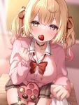  1girl black_skirt blonde_hair blurry blurry_background bow bowtie box breasts candy cardigan chocolate collared_shirt commentary depth_of_field desk double-parted_bangs food food_in_mouth hair_ribbon heart heart-shaped_box heart-shaped_chocolate heterochromia highres hoshikawa_sara hoshikawa_sara_(4th_costume) large_breasts looking_at_viewer meme_(mm_ta_mm) nijisanji official_alternate_costume on_desk pink_cardigan plaid plaid_skirt pleated_skirt pov red_bow red_bowtie red_eyes red_ribbon ribbon shirt shirt_grab sitting sitting_on_desk skirt symbol-only_commentary twintails wavy_hair white_shirt yellow_eyes 