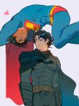  2boys batman batman_(series) batman_symbol belt black_cape black_eyeshadow black_hair blue_bodysuit blue_eyes bodysuit brown_belt cape closed_mouth dc_comics dollychoux eye_contact eyeshadow floating frown grey_eyes heart looking_at_another makeup male_focus multiple_boys muscular muscular_male red_cape short_hair smile standing superhero_costume superman superman_(2025) the_batman_(2022) upside-down yellow_belt 