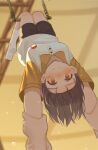  1girl 1other black_shorts blush brown_eyes brown_hair circus closed_mouth commentary full_body grow_up_show:_himawari_no_circus-dan highres holding_another's_wrist indoors looking_at_viewer milktea_(gggrrr2000) shirt short_hair short_sleeves shorts socks solo_focus sweat t-shirt trapeze tsurumaki_mizuka two-tone_shirt upside-down white_shirt white_socks yellow_shirt 