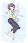  antenna_hair barefoot bed_sheet black_hair book capri_pants dabozero denim grin idolmaster idolmaster_(classic) jeans kikuchi_makoto looking_at_viewer lying on_side open_book pants pillow purple_eyes shirt shirt_lift short_hair short_sleeves smile solo t-shirt 