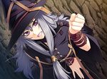 1girl angry benimura_karu bent_over breasts bunny_black cave clenched_teeth game_cg grey_hair hat highres long_hair looking_at_viewer purple_eyes solo teeth witch 