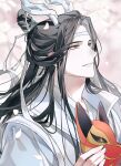  1boy black_hair chinese_clothes dragon_horns falling_petals fox_mask hair_bun hanfu highres holding holding_mask horns lan_wangji long_hair looking_up mask modao_zushi petals ribbon smile solo tassel white_hanfu white_ribbon white_som xiao_guan_(headdress) yellow_eyes 