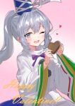  1girl ;d blue_headwear blush candy chocolate collared_shirt commentary_request double-parted_bangs food gift grey_eyes grey_hair hair_between_eyes hands_up happy happy_valentine hat heart heart-shaped_chocolate highres holding holding_gift kurapi_pref long_hair mononobe_no_futo neck_ribbon one_eye_closed open_mouth pink_background pom_pom_(clothes) ponytail purple_ribbon ribbon ribbon-trimmed_sleeves ribbon_trim shirt sidelocks simple_background smile solo tate_eboshi touhou upper_body valentine white_shirt wide_sleeves 