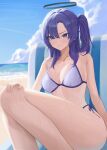  1girl ass bare_arms bare_legs bare_shoulders beach bikini blue_archive blush breasts closed_mouth collarbone day feet_out_of_frame hair_between_eyes halo highres large_breasts long_hair mechanical_halo ocean outdoors purple_eyes purple_hair solo starblue swimsuit thighs two_side_up wet white_bikini yuuka_(blue_archive) 