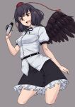  1girl belt bird_wings black_hair black_skirt black_wings breasts brown_eyes camera collared_shirt commentary cropped_legs frilled_skirt frills grey_background hat highres holding holding_camera kakone looking_at_viewer medium_breasts open_mouth shameimaru_aya shirt short_hair simple_background skirt solo teeth tokin_hat touhou upper_teeth_only white_shirt wings 