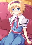  alice_margatroid blonde_hair blue_dress blue_eyes blush capelet commentary couch dress hairband highres lolita_hairband looking_at_viewer naba_(take_tonbo) puffy_sleeves sash short_hair short_sleeves sitting smile solo touhou 