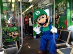  gloves hat luigi mario_(series) mascot new_super_mario_bros. new_super_mario_bros._u nintendo overalls photo sunglasses super_mario_bros. train waving 