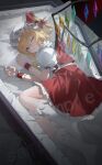  1girl :o ;o absurdres blonde_hair bow coffin collared_shirt commentary_request flandre_scarlet frilled_shirt_collar frilled_skirt frills hair_between_eyes hair_bow hat highres kneehighs long_hair looking_at_viewer lying mob_cap nabenyaa on_side one_eye_closed pillow puffy_short_sleeves puffy_sleeves red_bow red_eyes red_skirt red_vest sample_watermark shirt short_sleeves skirt socks solo touhou vest watermark white_hat white_shirt white_socks wings wrist_cuffs 