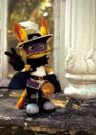  1girl :3 black_hat cape cat digimon digimon_(creature) extyrannomon eye_mask figure_(medium) furry furry_female green_eyes hat hat_feather highres looking_at_viewer mask nyabootmon outdoors photo_(medium) pillar purple_mask rapier smile solo sword v weapon whiskers 