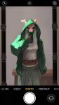  1girl adapted_costume alfish7 breasts cowboy_shot dark-skinned_female dark_skin facing_ahead facing_viewer fake_phone_screenshot fake_screenshot green_hoodie grey_pants hand_up highres holding holding_phone hood hoodie long_hair long_sleeves mask medium_breasts midriff mirror_selfie open_clothes open_hoodie pants phone selfie shirt skull_mask slay_the_spire sleeves_past_wrists solo the_silent_(slay_the_spire) user_interface white_hair white_shirt 