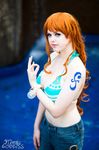 1girl bracelet breasts cosplay flaming-goddess highres jewelry large_breasts nami nami_(cosplay) nami_(one_piece) nami_(one_piece)_(cosplay) one_piece orange_hair photo solo tattoo 