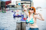  baltimore bikini_top blurry bracelet breasts cleavage cosplay denim depth_of_field flaming-goddess glasses huge_breasts jeans jewelry large_breasts nami nami_(cosplay) nami_(one_piece) nami_(one_piece)_(cosplay) one_piece orange_hair outdoors pants photo sitting solo water 