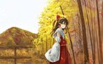  ascot autumn_leaves blush bow brown_eyes brown_hair detached_sleeves forest hair_bow hair_tubes hakurei_reimu kinoto_(ruindivinity) leaf long_hair mountain nature skirt smile solo touhou 