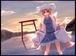  blonde_hair border breasts cloud dress dutch_angle fox_tail hat highres impossible_clothes impossible_dress lens_flare liya looking_at_viewer medium_breasts mountain multiple_tails open_mouth pillow_hat red_eyes reflection short_hair skirt skirt_lift sky solo sparkle sun sunset tabard tail tassel torii touhou wading yakumo_ran 