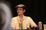  alcohol beer cup glasses green_shirt hat lanyard looking_away male_focus photo real_life shirt solo table zun 