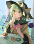  1girl black_hat blush bow buttons closed_mouth collared_shirt commentary_request cup diamond_button disembodied_linked_eye donut eating eyeball food food_on_face frilled_shirt_collar frilled_sleeves frills green_eyes green_hair hat hat_bow heart heart_of_string highres holding holding_donut holding_food komeiji_koishi long_sleeves plate saucer shirt solo table teacup touhou wide_sleeves yellow_bow yellow_shirt yoizumi 