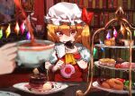  1girl 1other ascot blonde_hair blurry blurry_foreground bookshelf cake cowboy_shot crystal_wings cup doughnut eating flandre_scarlet food ga-chan24 hat hat_ribbon indoors mob_cap pointy_ears red_ribbon ribbon sitting solo_focus table tea teacup touhou yellow_ascot 